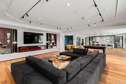 a living room with a large gray couch and a television