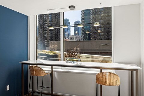 a kitchen with a large window and a table with two chairs