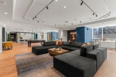 a large living room with couches and a pool table