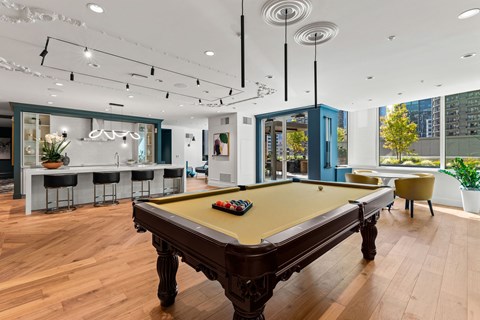 a game room with a pool table and a bar