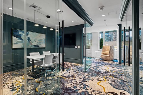 a conference room with glass walls and a table and chairs