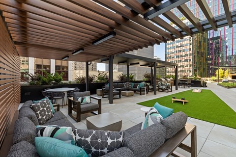 a lounge area with couches and tables on a patio