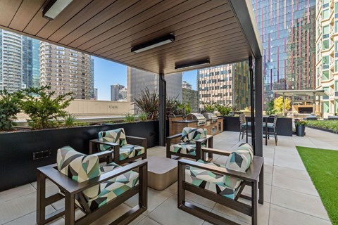 a terrace with chairs and tables and a view of the city
