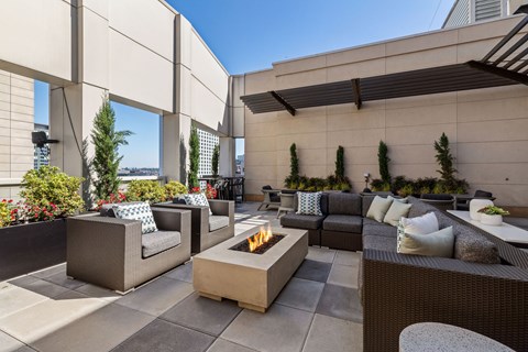an outdoor patio with furniture and a fire pit