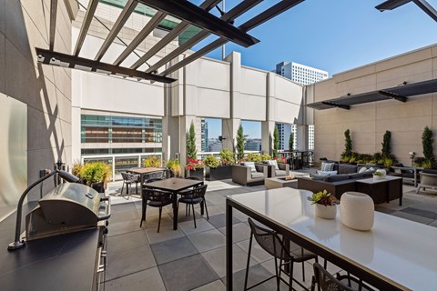 a rooftop patio with tables and chairs and a sink