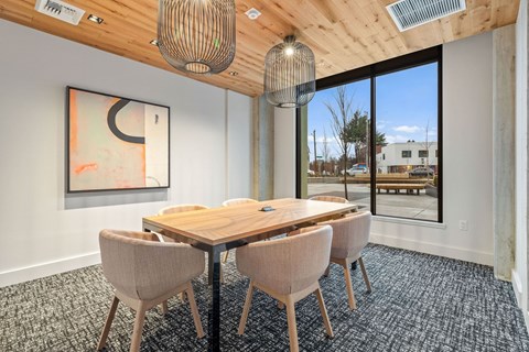 A conference room with a large table and chairs.