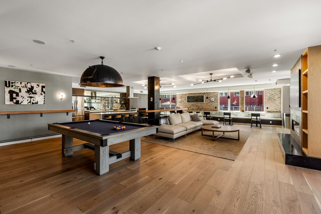 A room with a pool table and a couch.