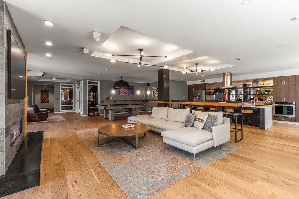 A modern living room with a white sofa and a coffee table.