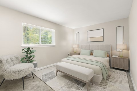 A bedroom with a large bed, a chair, and a potted plant.
