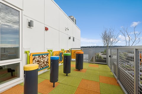 A white building with a green and orange tiled floor.