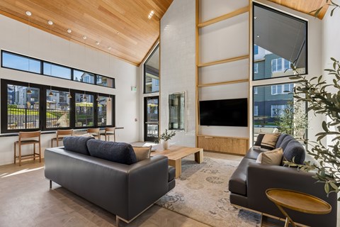 A modern living room with a large couch and a television.