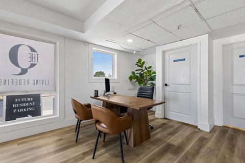 A room with a table and chairs and a sign that says "Future Resident Parking".