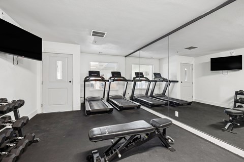 Fitness center with treadmills and weight equipment at The Q Apartments, Washington, 99336