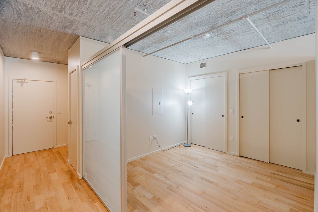A room with wooden floors and white walls.