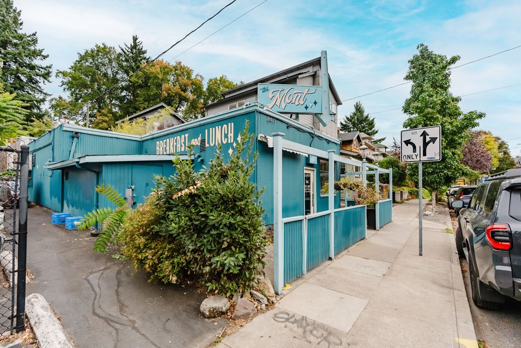 A blue building with a sign that says