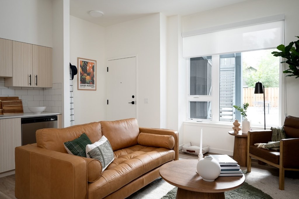 The Wes Gresham Oregon Apartments living room with leather couch and table