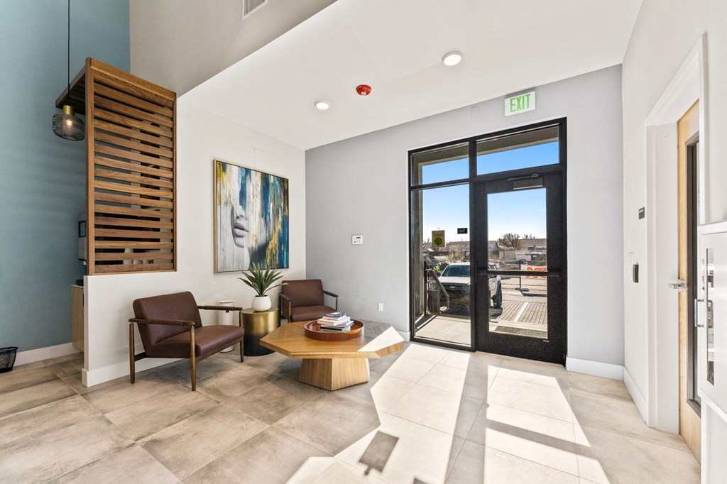 a living room with a table and chairs and a door to a balcony