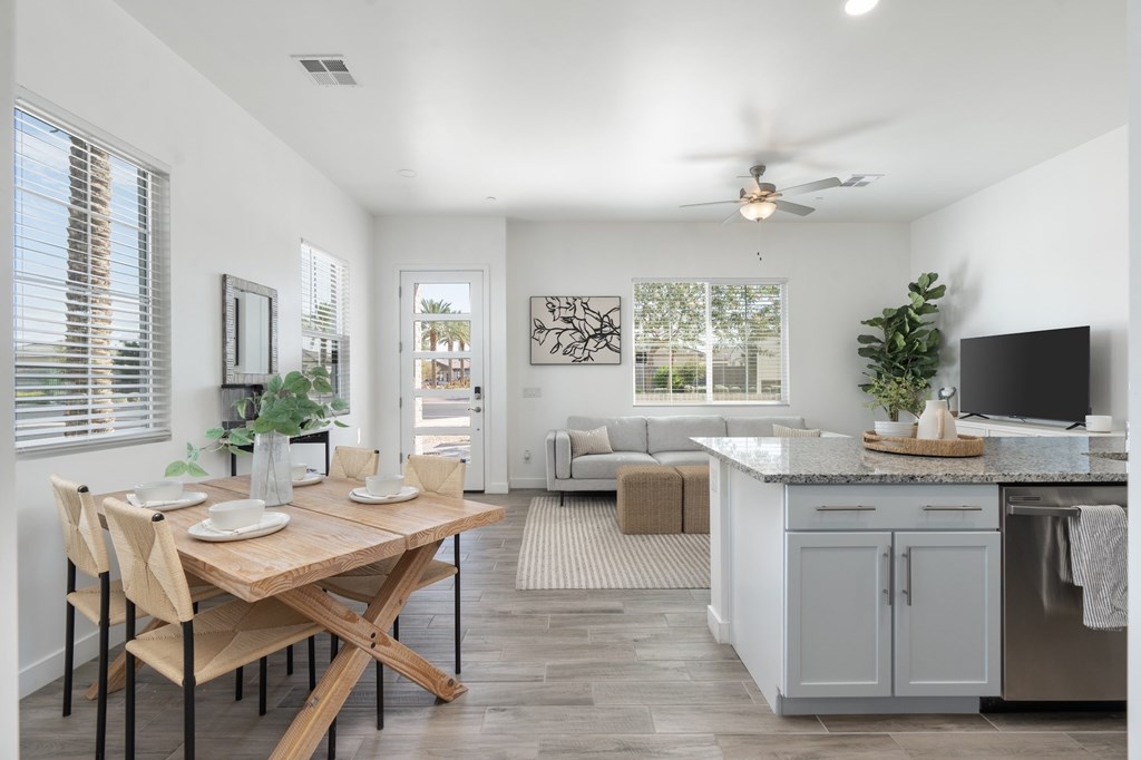 A kitchen with a table and chairs in the middle of the room.