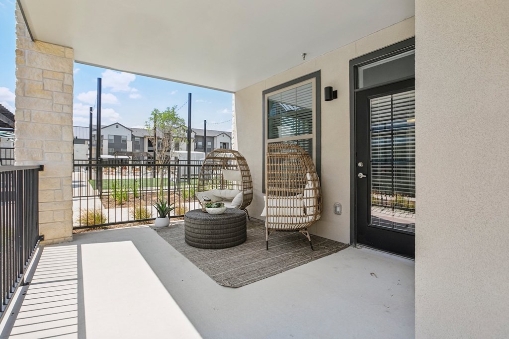 A patio with a chair and a table.