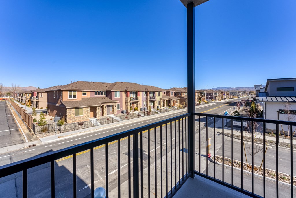 a balcony with a view of a street and some buildings