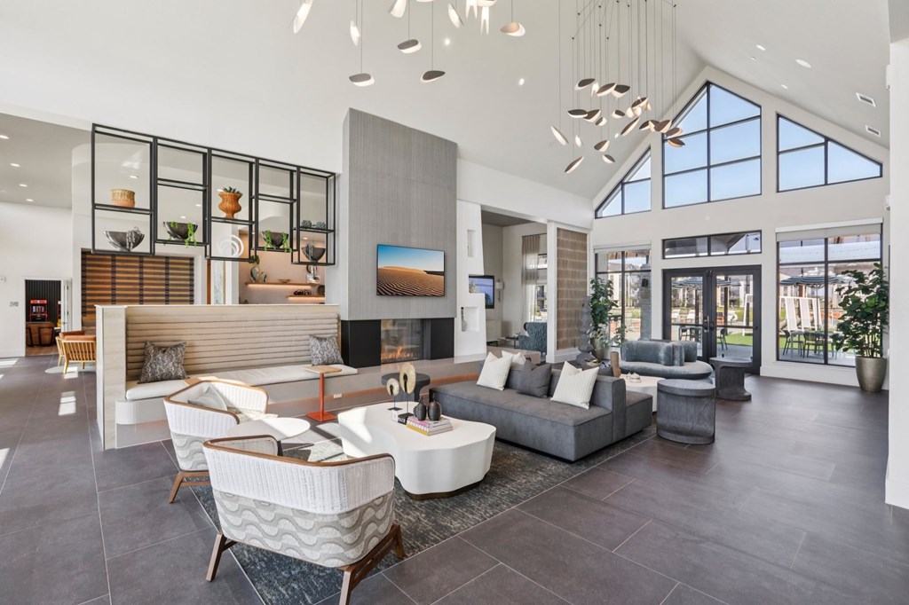 A modern living room with a large grey sofa and a wooden coffee table.