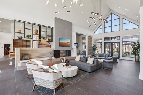 A modern living room with a large grey sofa and a wooden coffee table.
