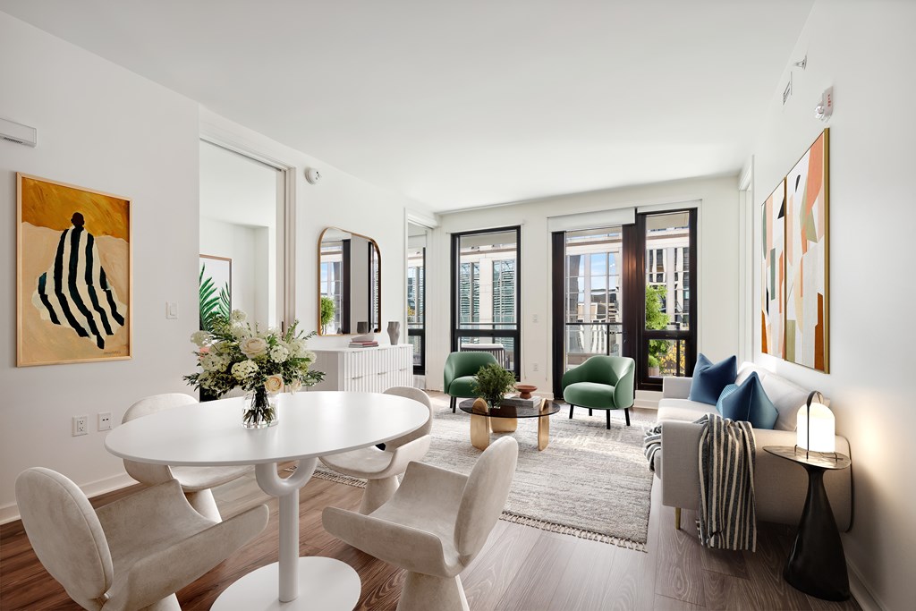 A modern dining room with a white table and chairs.