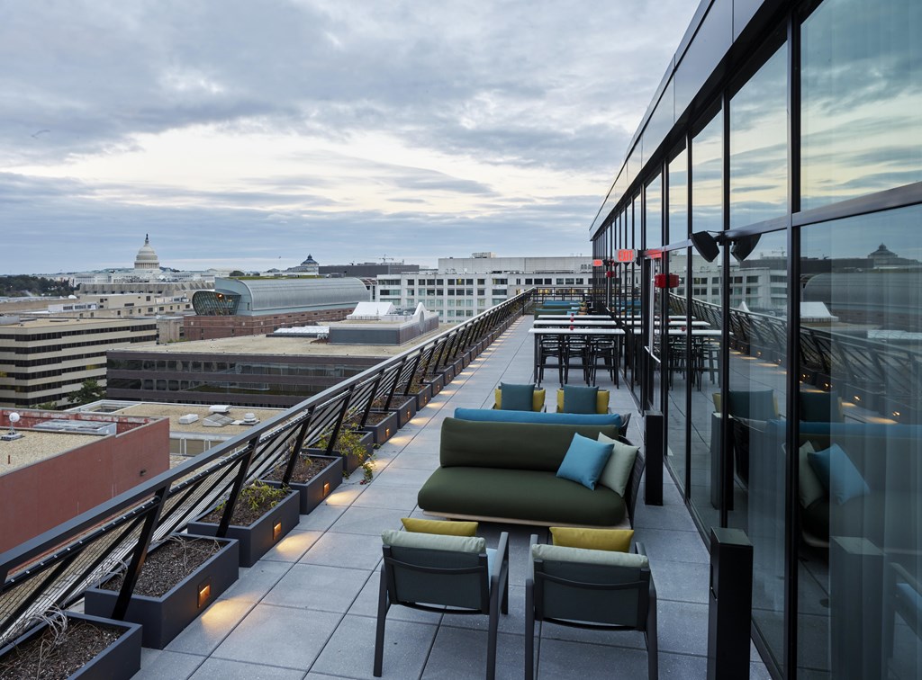 A rooftop patio with a view of the city.