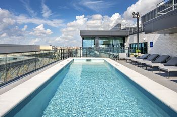 A long rectangular pool with a glass wall on one side.
