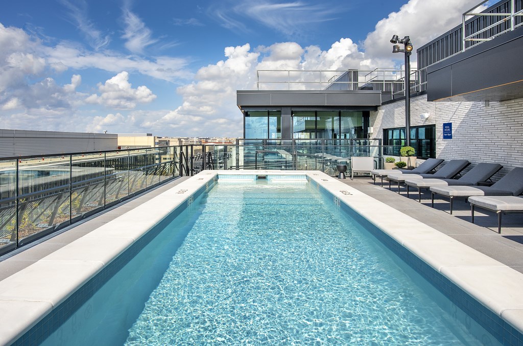 A long rectangular pool with a glass wall on one side.