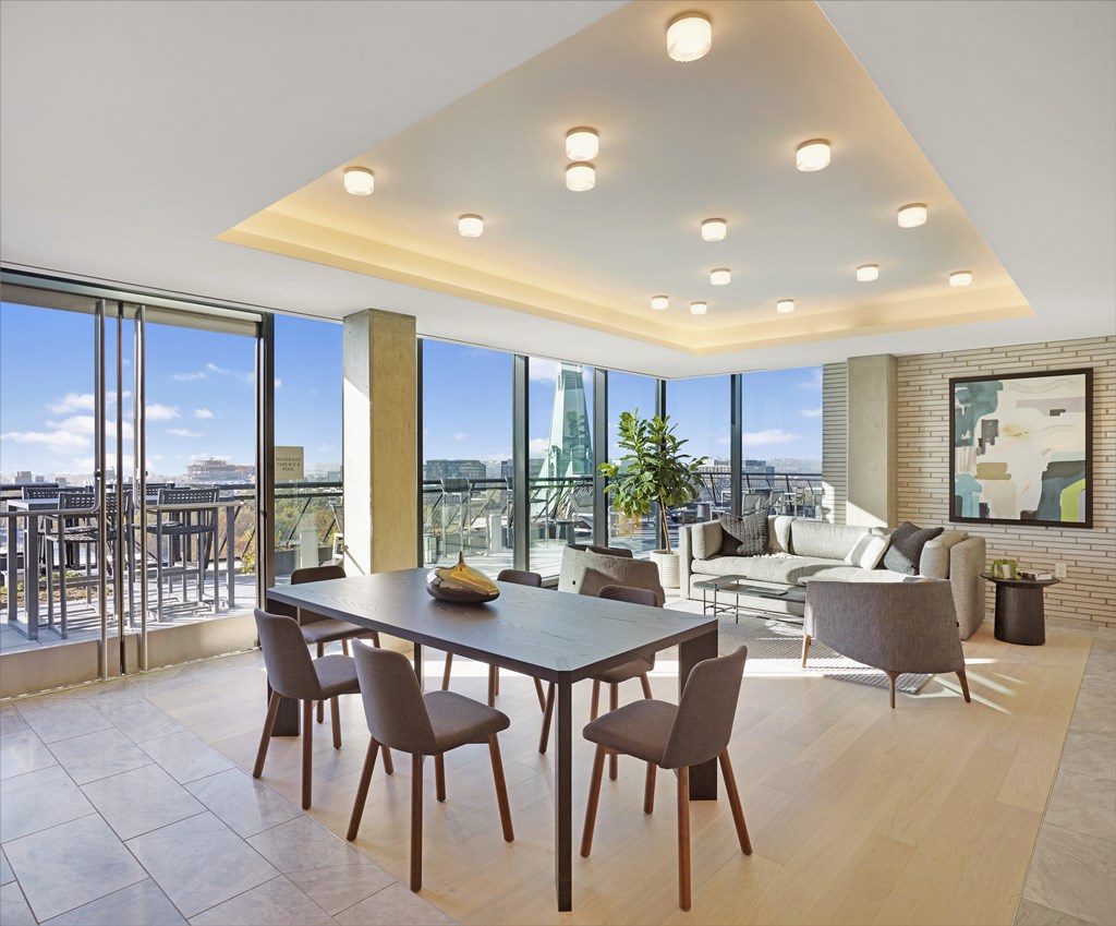 A modern dining room with a large table and chairs.