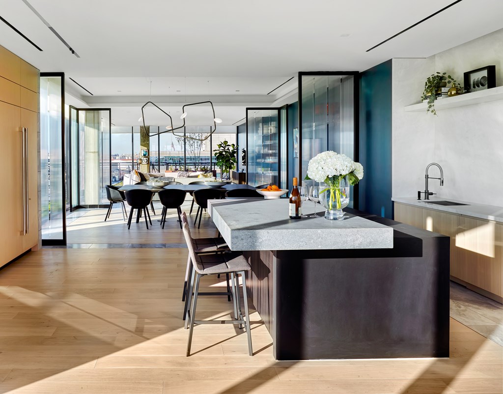 A modern kitchen with a table and chairs.