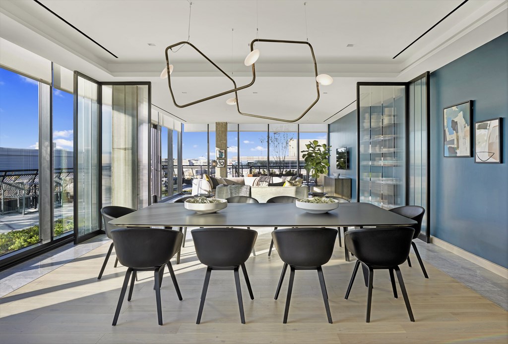 A modern dining room with a table set for four.