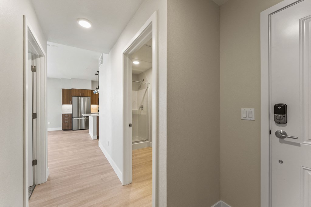 a view of the hallway from the front door of a house