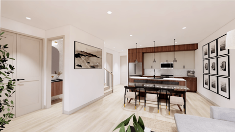 A modern kitchen with a dining table and chairs.