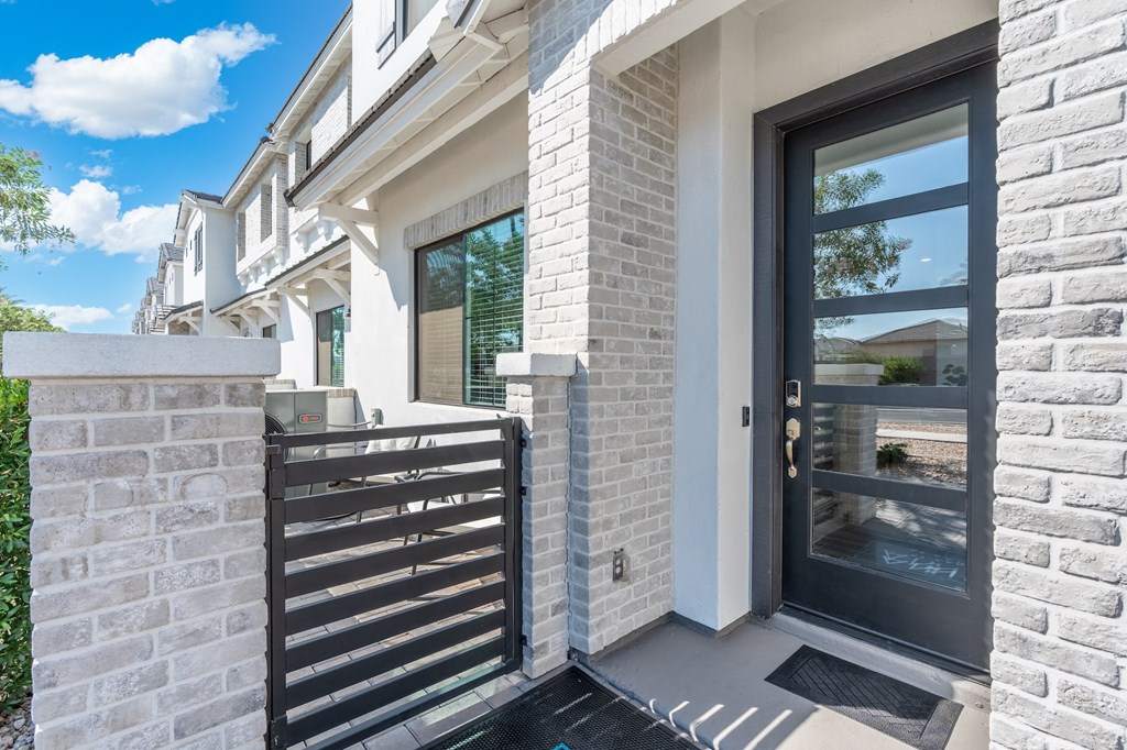 A modern house with a black gate and a glass door.