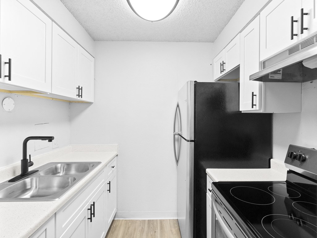 Proximity Apartment Homes Kitchen with stainless steel appliances and white cabinets