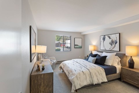 A bedroom with a large bed and a window.