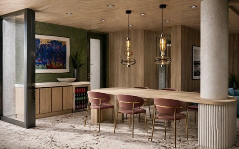 A modern dining room with a long table and chairs.