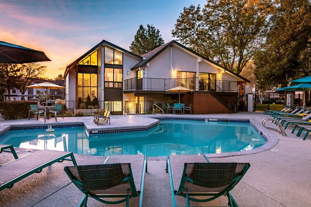 Clover Creek Apartments Pool Area and Lounge Chairs at Dusk