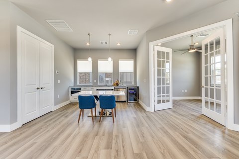 A dining room with a table and chairs.