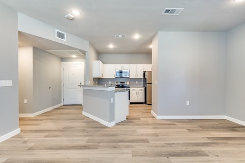 A kitchen with a white counter and cabinets is shown.