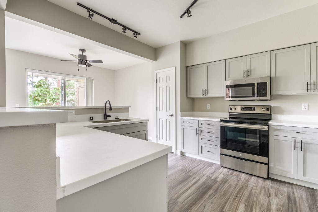 a kitchen with white cabinets and a white counter top