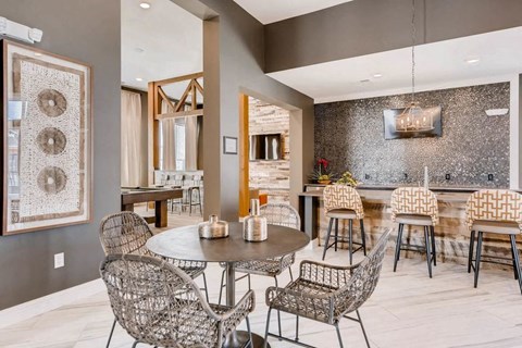 a dining room with a table and chairs and a kitchen