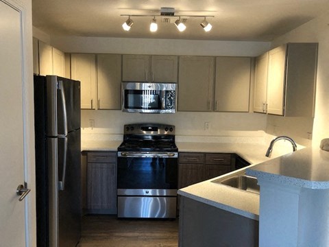 a kitchen with stainless steel appliances and white cabinets