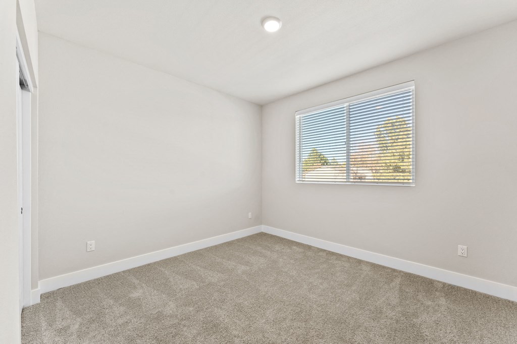 an empty room with a window and a mural on the wall