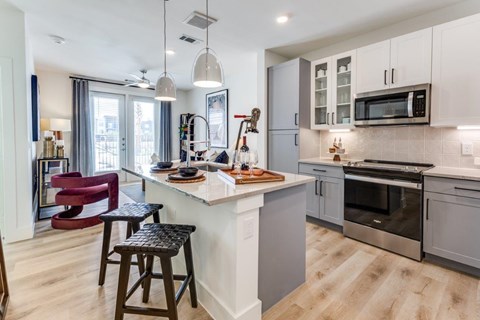 A modern kitchen with a bar stool and a countertop.