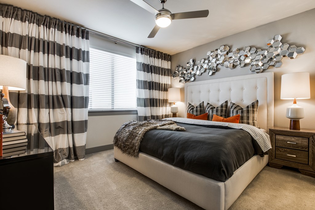a bedroom with a bed and a ceiling fan