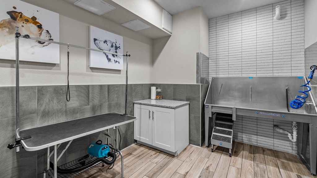 a utility room with stainless steel appliances and a sink