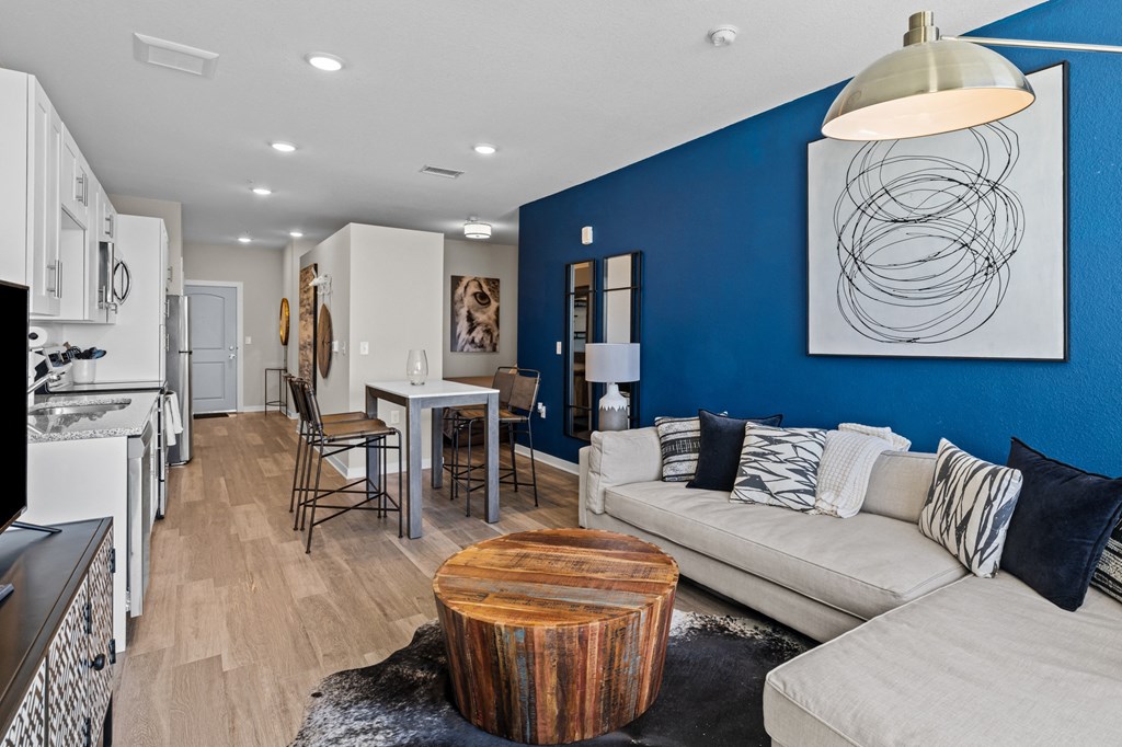 a living room with a blue wall and a couch and a table